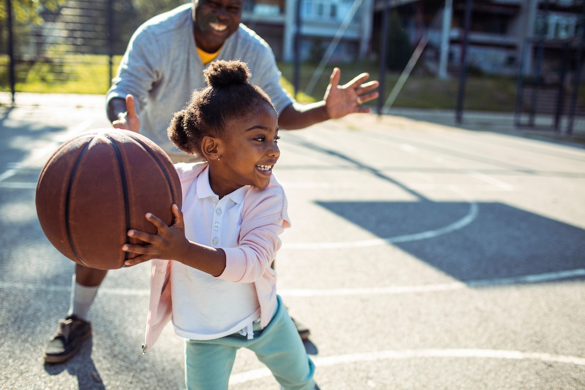 child playing basketball outside